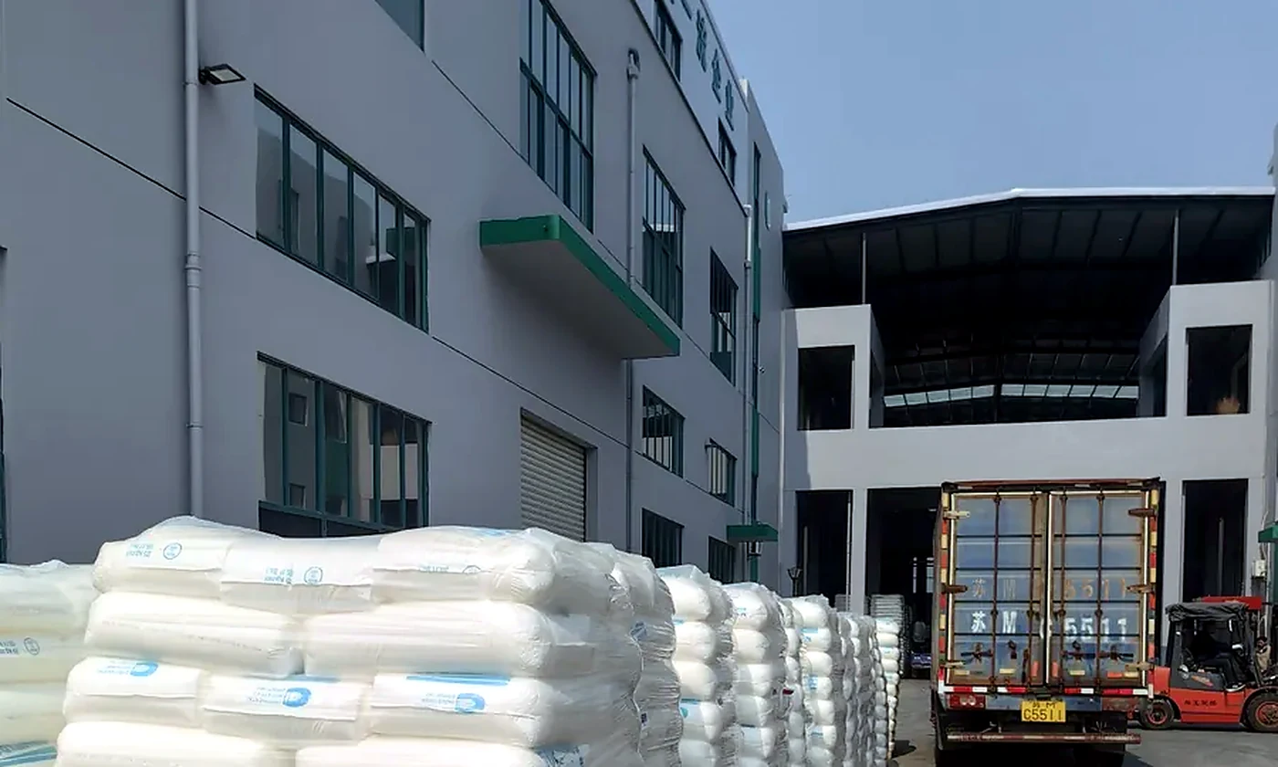 OKISS real loading yard with staged cartons and export truck